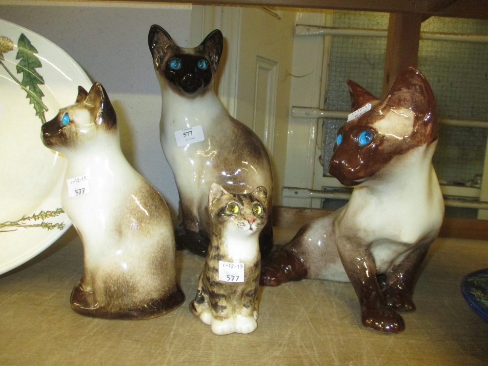 Four various Winstanley pottery figures of cats