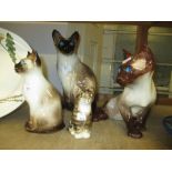 Four various Winstanley pottery figures of cats