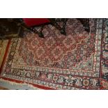 Indo Persian rug on a red and blue ground with multiple borders,