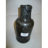 Unusual antique glass bottle with wide neck above a cylindrical body and inverted dome base,