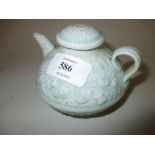 Chinese porcelain water dropper with cover with relief moulded decoration on a pale turquoise