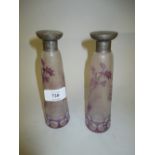 Pair of mauve and clear cut glass scent bottles with later silver covers