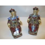 Pair of 20th Century Chinese slip glazed stoneware figures of seated Immortals,