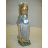 Large Lladro biscuit porcelain figure of a standing girl with a puppy