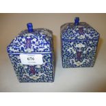 Pair of 20th Century Chinese square shaped canisters with covers decorated with floral designs on a