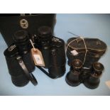 Pair of leather cased field binoculars with leather grips and a pair of 20th Century cased