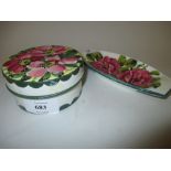 Wemyss circular box and cover painted with flowers together with a similar oval dish,