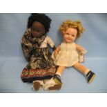 Bisque headed Negro doll marked 34-28 on a jointed composition body together with another doll