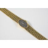 A LADY'S 18CT. GOLD WRISTWATCH BY KUTCHINSKY the signed oval grey dial with baton numerals, on an