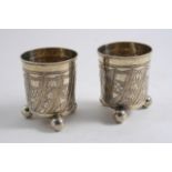 A PAIR OF 18TH CENTURY RUSSIAN BEAKERS with firm chased & wrythen-fluted decoration & three ball