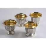 A SET OF FOUR VICTORIAN ENGRAVED OCTAGONAL SALTS crested, gilt interiors, by C. Reily & G. Storer,