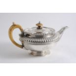 A GEORGE IV SQUAT CIRCULAR TEA POT with an ivory handle & finial, a part-fluted upper body & a