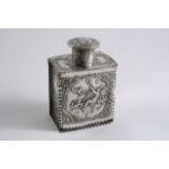 A CONTINENTAL EMBOSSED TEA CADDY of panelled form with crimped borders & a pull-off measuring cap,