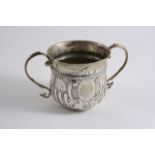 A GEORGE III PORRINGER with twin S-scroll handles, decorated with embossed part-fluting, a