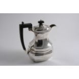 A MODERN HOT WATER JUG with a waisted neck, an angular handle & a flat base, maker's mark worn,