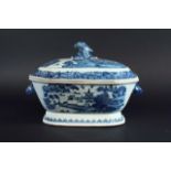 A BLUE AND WHITE SOUP TUREEN AND COVER painted with a river landscape, rabbits mask handles,