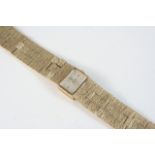 A LADY'S 9CT. GOLD WRISTWATCH BY ROTARY the signed rectangular-shaped dial with baton numerals, on