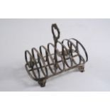 A VICTORIAN TOAST RACK with seven reeded bars & a central handle, bracket feet by William Evans,