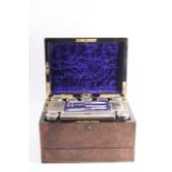 A VICTORIAN BRASS BOUND WALNUT DRESSING CASE fitted with ten mounted glass bottles/boxes/jars,