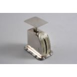 AN EDWARDIAN POSTAL SCALE on a shaped oblong base, graduated from one to sixteen ounces (loaded), by