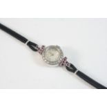 A LADY'S DIAMOND AND RUBY COCKTAIL WRISTWATCH BY BENSON the signed circular dial with Arabic