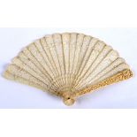 A CHINESE BRISE IVORY FAN guards and sticks carved with figures & pavilions; 20 cms