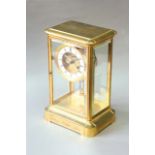 AN ORMOLU FOUR GLASS CLOCK dial white enamel, with exposed escapement and foliate engraved plate