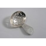 A GEORGE III DOUBLE-DUTY CADDY SPOON with a bright-cut, coffin-end, initialled & a pierced bowl,