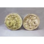 A PAIR OF PAINTED CARVED WOOD HERALDIC ROUNDELS each carved in high relief with a cartouche