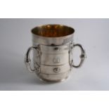 A LARGE VICTORIAN THREE-HANDLED CUP OR TYG with studded & banded decoration & a ring foot,