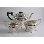 A MODERN THREE-PIECE TEA SET with shaped oval bodies and paw feet, by Walker & Hall, Sheffield 1912;