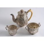 A LATE VICTORIAN THREE-PIECE BACHELOR'S TEA SET with embossed decoration, the tea pot with an