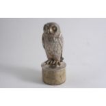 A CONTEMPORARY CAST MODEL OF AN OWL with textured plumage, a domed circular base and an integral