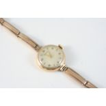 A 9CT. GOLD WRISTWATCH BY VERTEX the circular signed dial with Arabic and dagger numerals, on an