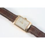 AN ART DECO GOLD WRISTWATCH BY RECORD the signed rectangular dial with Arabic numerals and