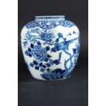 A BLUE AND WHITE JAR painted with exotic birds, perched amongst flowering plants issuing from