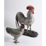 A LATE 19TH / EARLY 20TH CENTURY BASE-METAL MODEL OF A COCKEREL on a wooden base and a hen, both