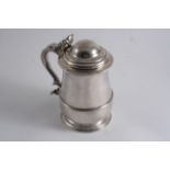 A GEORGE II TANKARD of squat baluster form with an applied reeded girdle & a domed cover, by R.