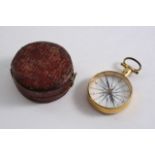 AN EARLY 19TH CENTURY GILT METAL POCKET COMPASS the white enamelled dial with black, Roman