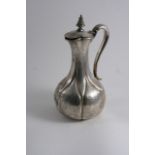 A VICTORIAN ENGRAVED HOT WATER JUG OR EWER of baluster form with engraved & fluted decoration,