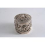 A LATE 19TH CENTURY INDIAN EMBOSSED CYLINDRICAL BOX & COVER, very low grade, with native scenes (