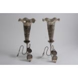 A PAIR OF EARLY 20TH CENTURY INDIAN EMBOSSED VASES  on tendril supports with leaf feet, unmarked,