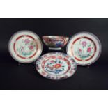 A PAIR OF FAMILLE ROSE PLATES each delicately painted with flowering plants, 8 3/4ins. (22.5cms.)