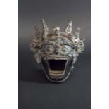 A BRONZE INCENSE BURNER possibly Nepalese, cast as a fearsome mask, the diadem set with human