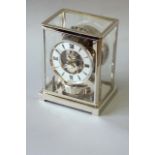 A LE COULTRE ATMOS CLOCK case rodium, no. 84736, 8 3/4ins. (22cms.) high, together with a box