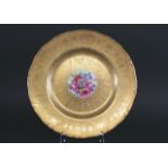 ROYAL WORCESTER SIGNED PLATE painted with a central panel of flowers and rich gilded decoration.