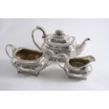 A GEORGE III THREE-PIECE EMBOSSED TEA SET with bellied, rounded oblong bodies & ornate paw feet, C-