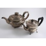 A GEORGE IV SQUAT CIRCULAR TEA POT on paw feet with embossed & fluted decoration, by William