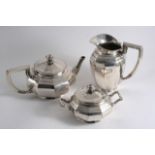 A 20TH CENTURY GERMAN TEA POT, HOT WATER JUG & COVERED SUGAR BOWL with squat, ten-sided bodies and