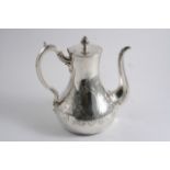 A VICTORIAN ENGRAVED COFFEE POT of baluster form with a flat base, scroll handle & bud finial,